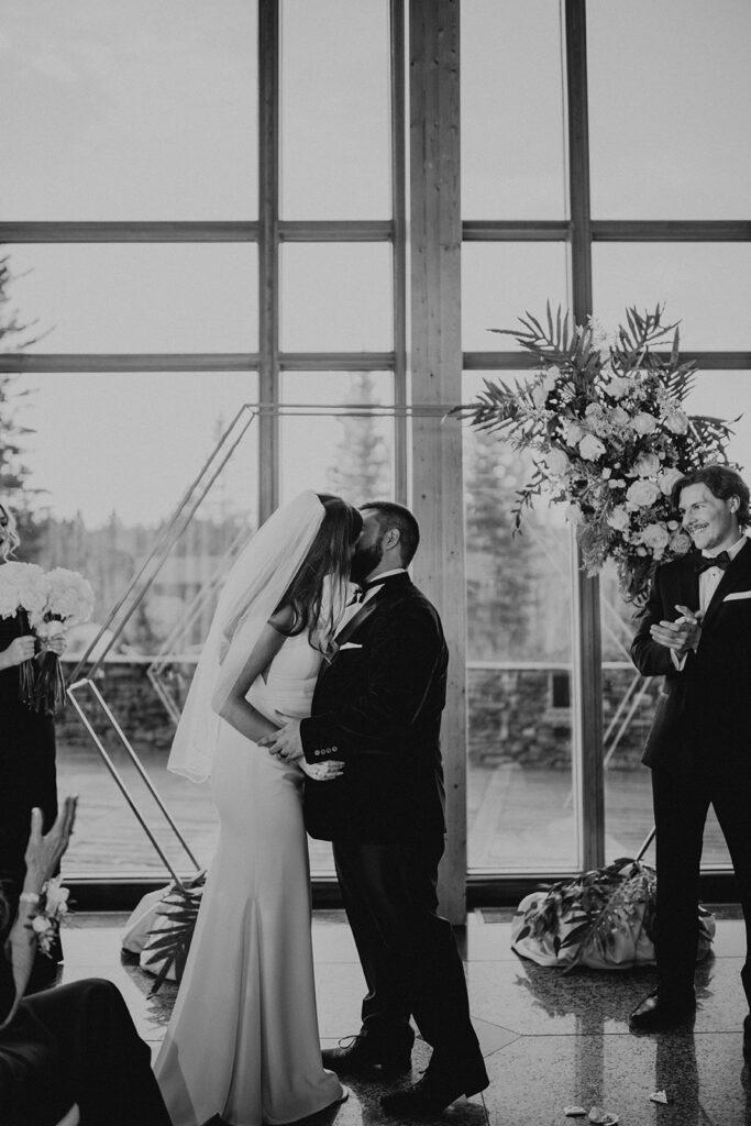 Bride and groom kissing during wedding ceremony